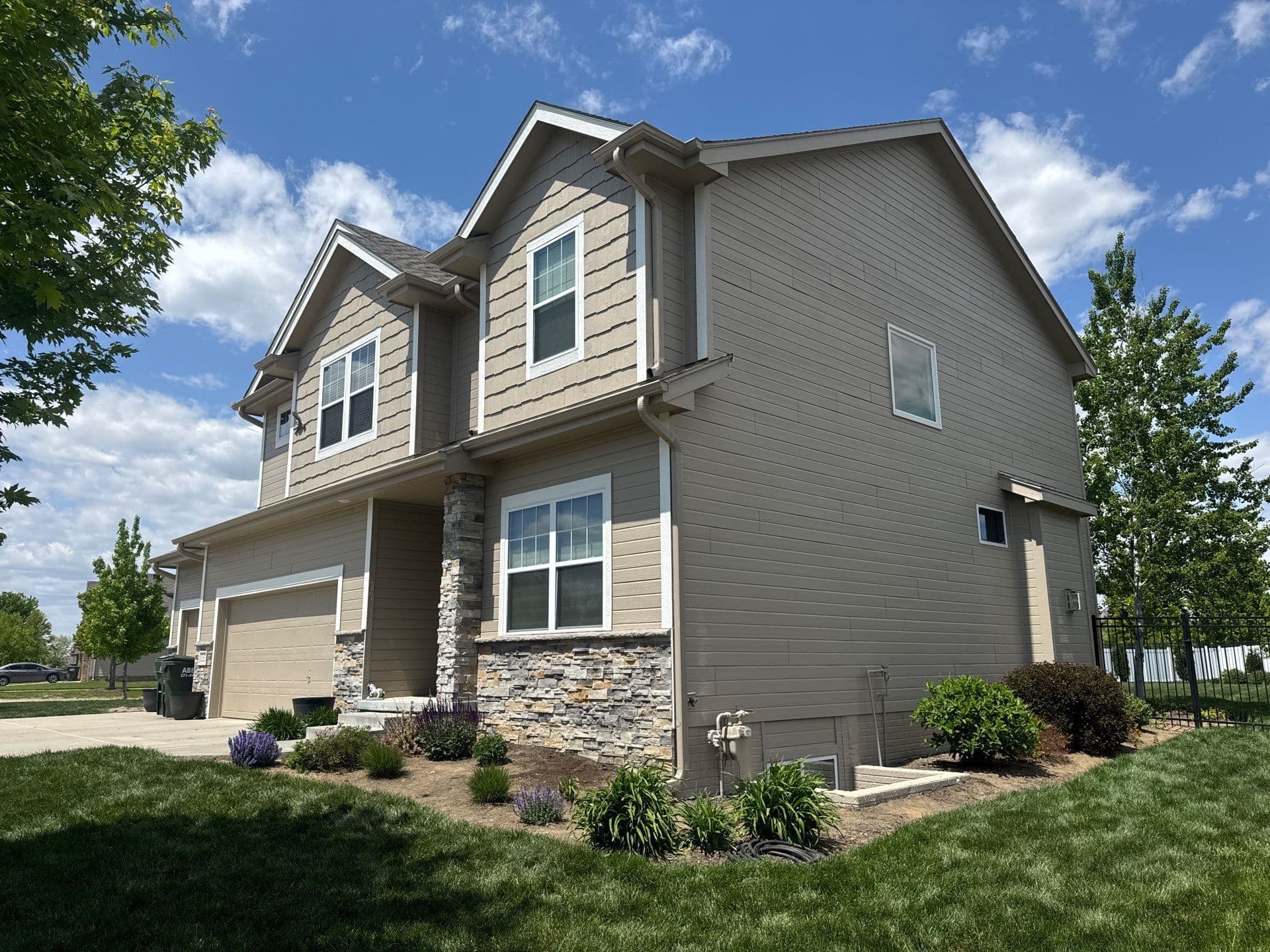 Project New Roof, Gutters, and Fresh Paint on This Two-Story Home image